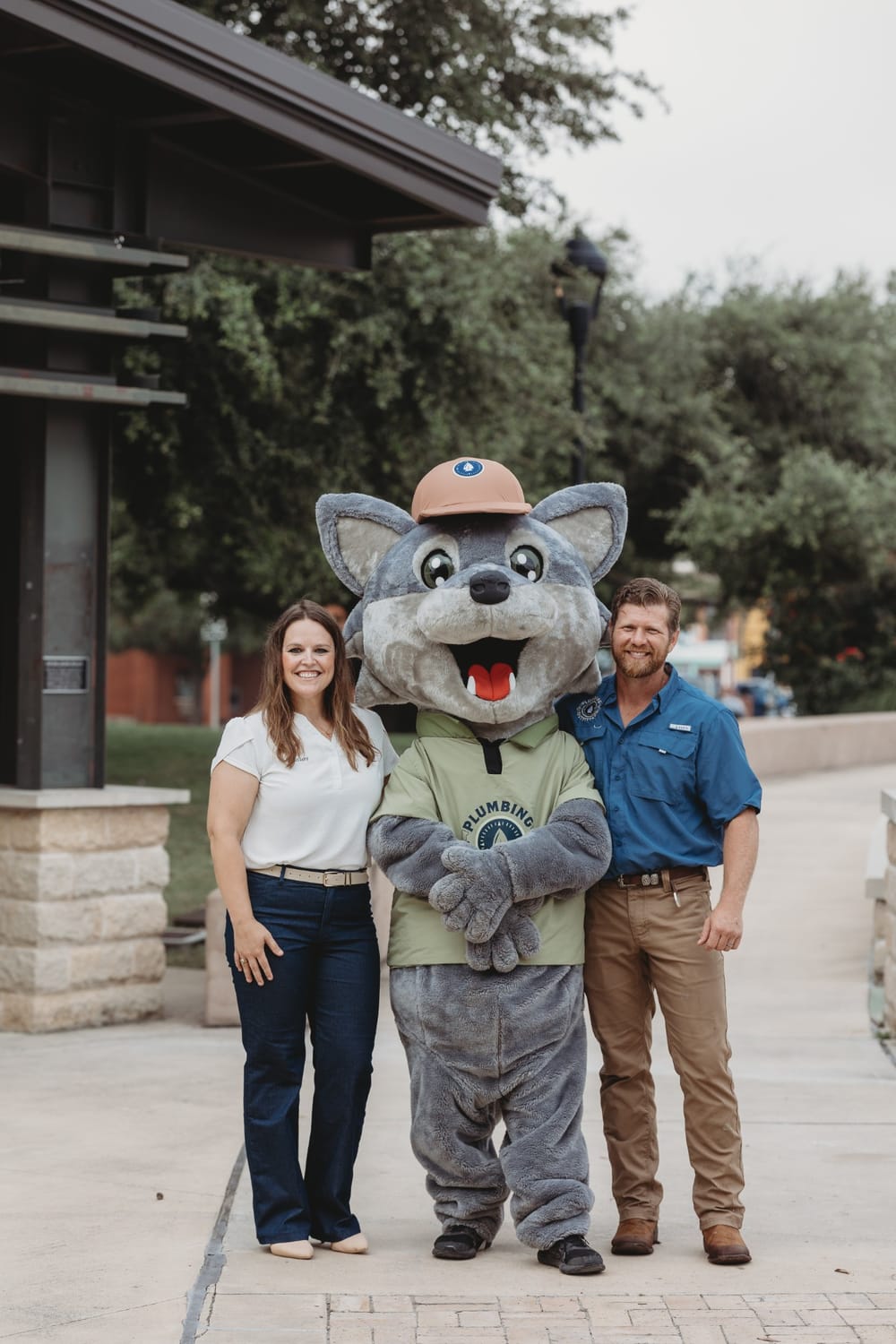 The Plumbing Outfitters team with Wayfinder Wolf, the company mascot