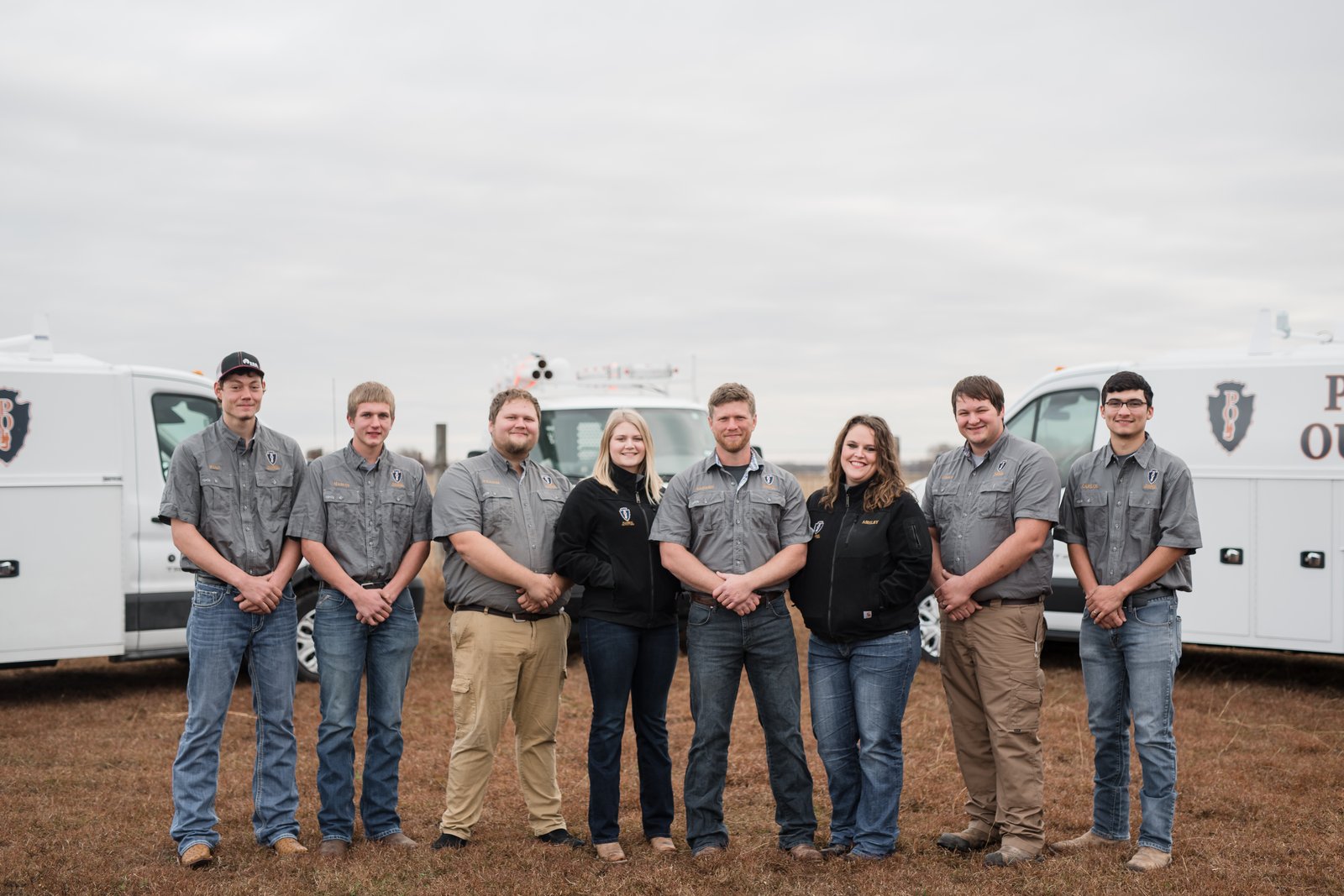The early Plumbing Outfitters team standing in front of the fleet