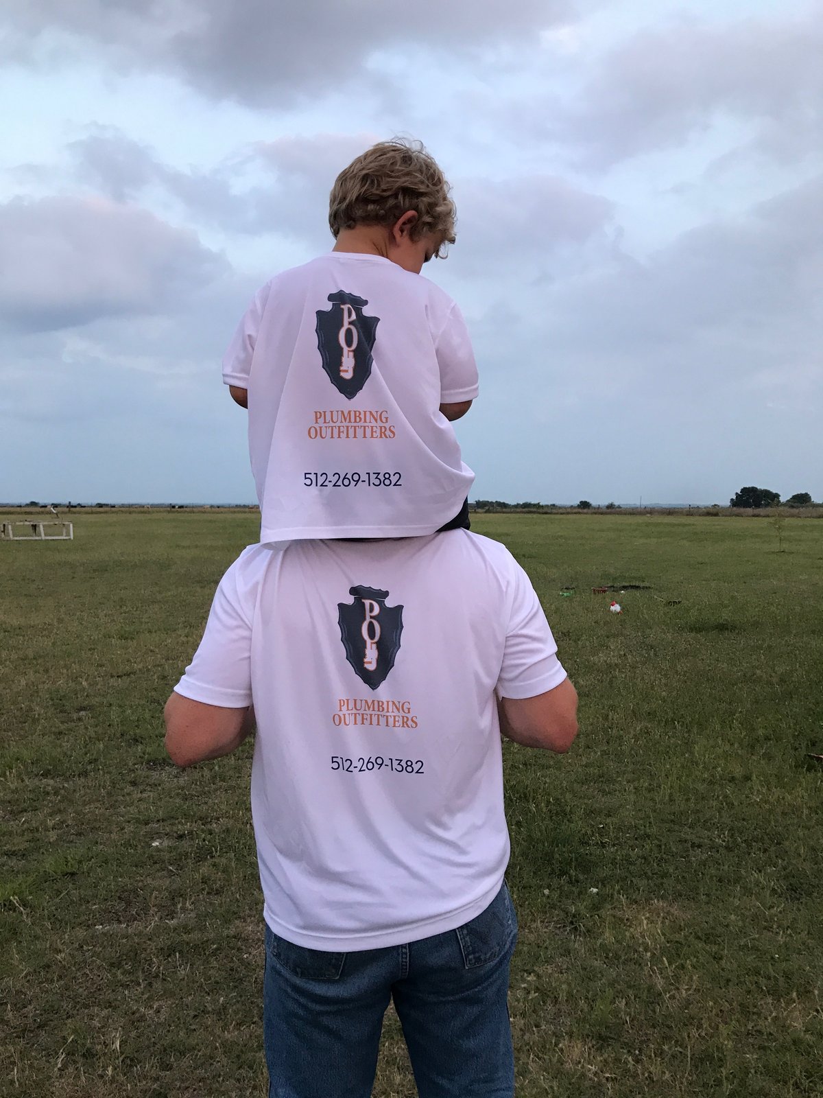 A Plumbing Outfitters team member with his son, both wearing company shirts