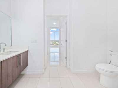 Modern bathroom interior featuring a white toilet and a stylish vanity, relevant to Cedar Park toilet repair solutions.