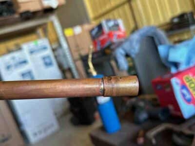 Copper gas pipe showing wear and potential damage, emphasizing the need for professional gas piping repair services in Austin, TX.