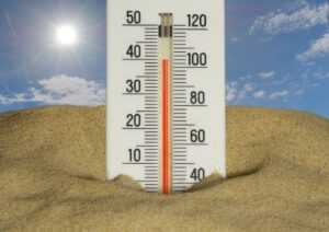 summer heat beating down on a residential home with visible pipes