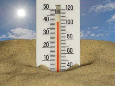 summer heat beating down on a residential home with visible pipes